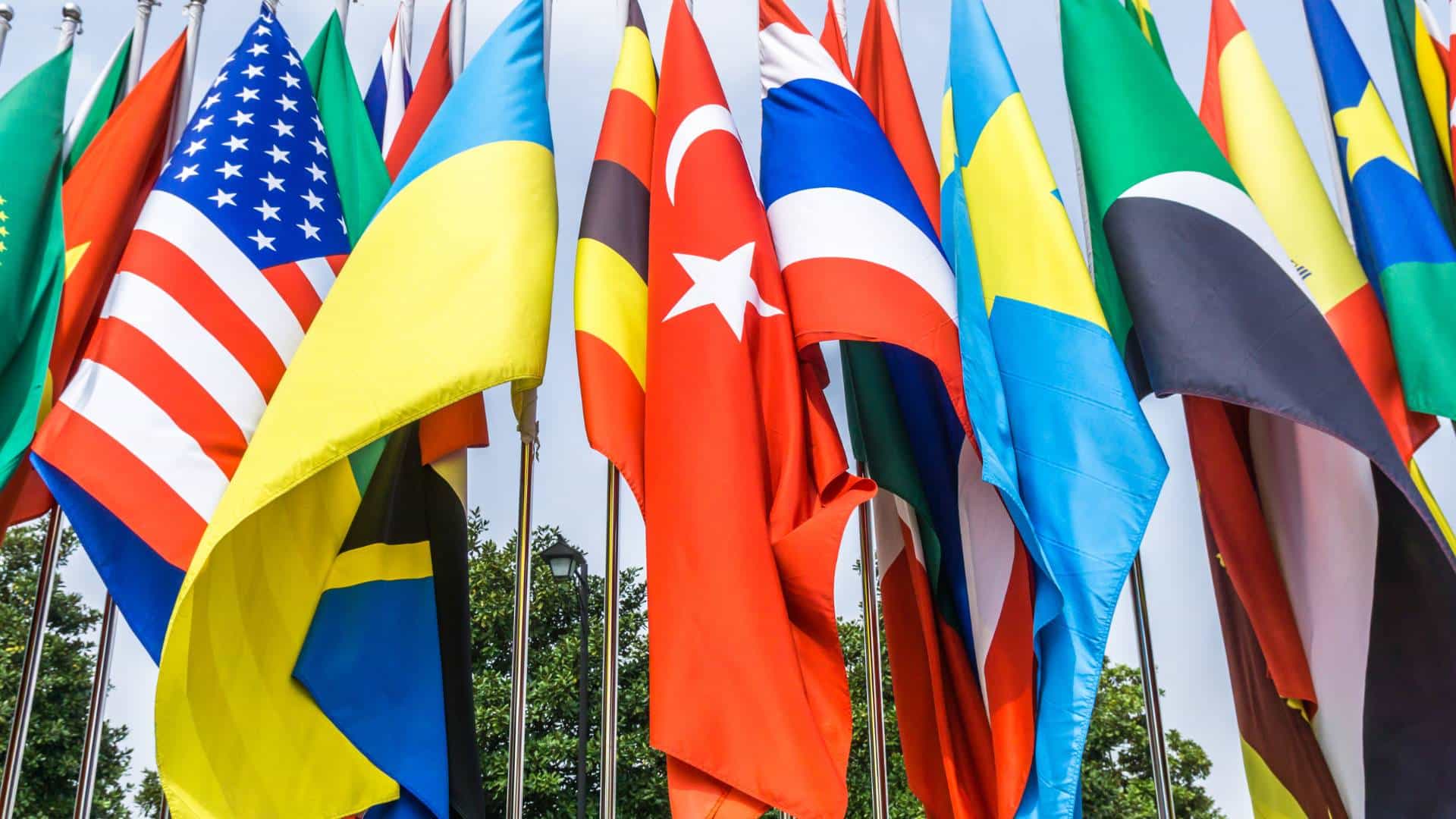 The entrance to the United Nations in Geneva is obscured by the emblems of a dozen international economic and political organizations.