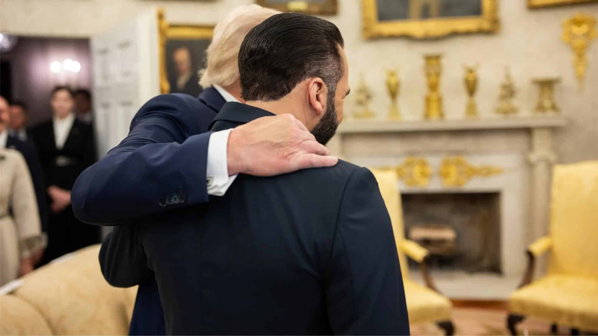 A man carries a child as they are taken into custody by officials at the Texas-Mexico border