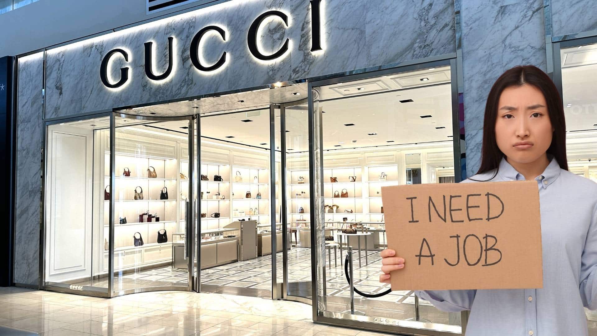 Woman holds a sign looking for a job in front of a Gucci store. 