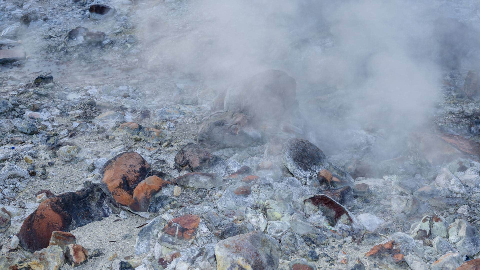 Steam rises from the ground at a geothermal plant