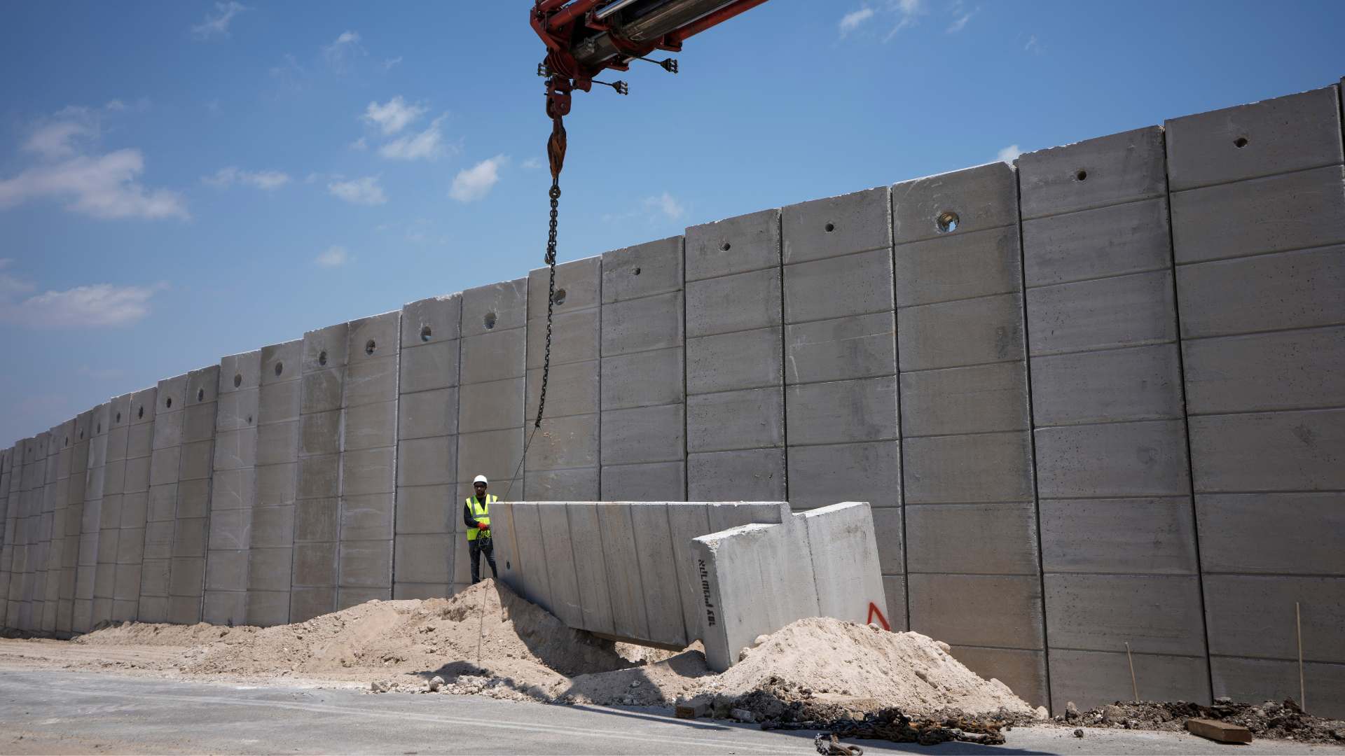 Two state solution Workers place sections of a nine-meter (30-foot) high concrete wall to replace a border fence between the northern West Bank and Israel