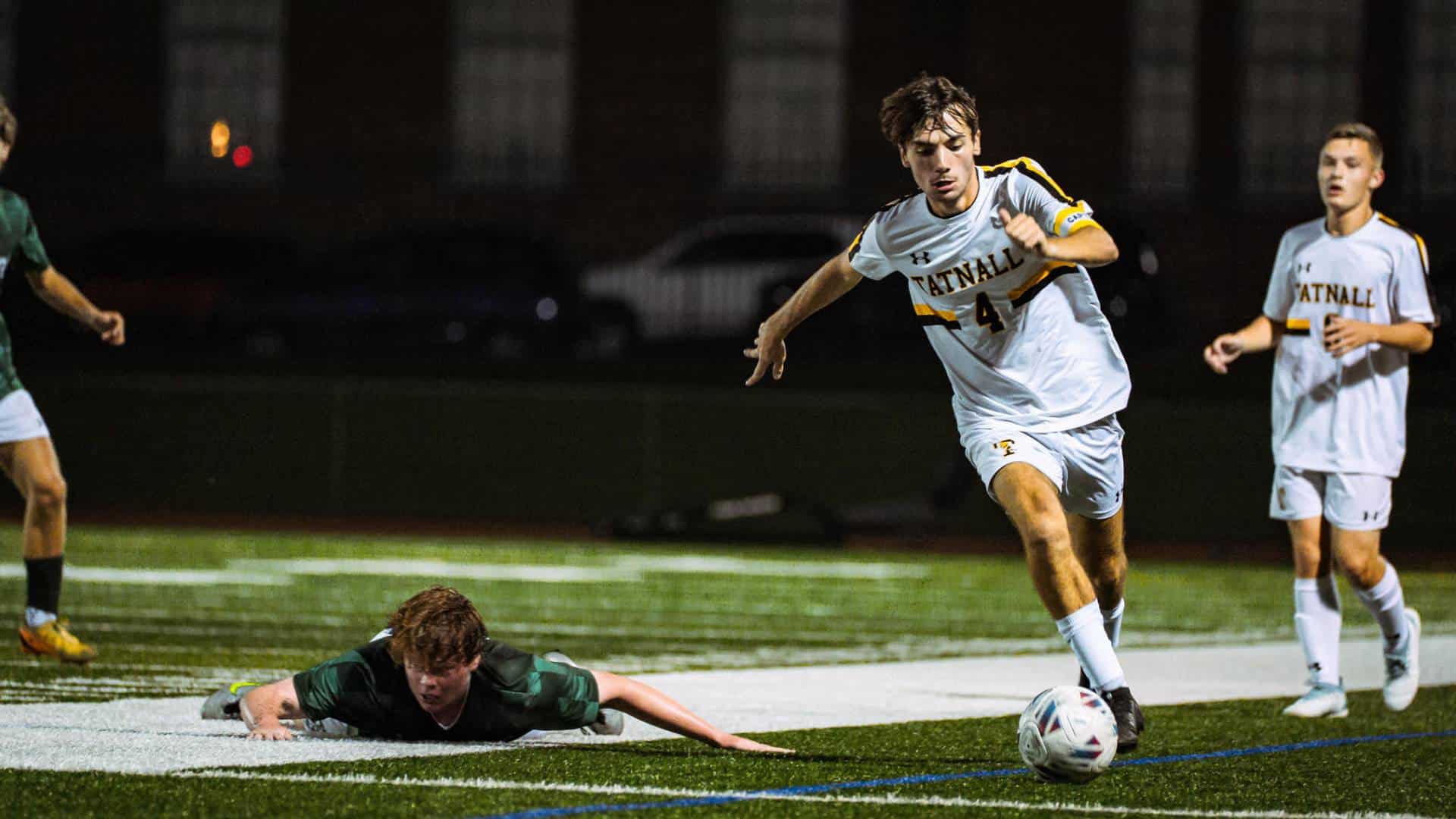 The author driving the ball during a soccer game.