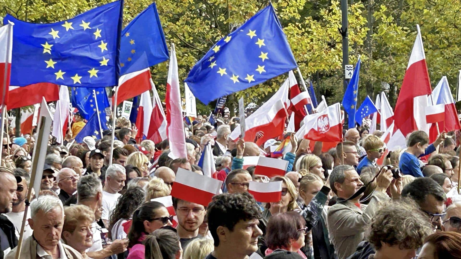 A woman walks by the European Union House in Riga, Latvia. 