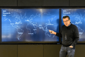 Tulevski George Tulevski stands next to a world map