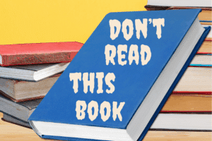 book bans (900 x 600 px) A book on a shelf comes with a warning.