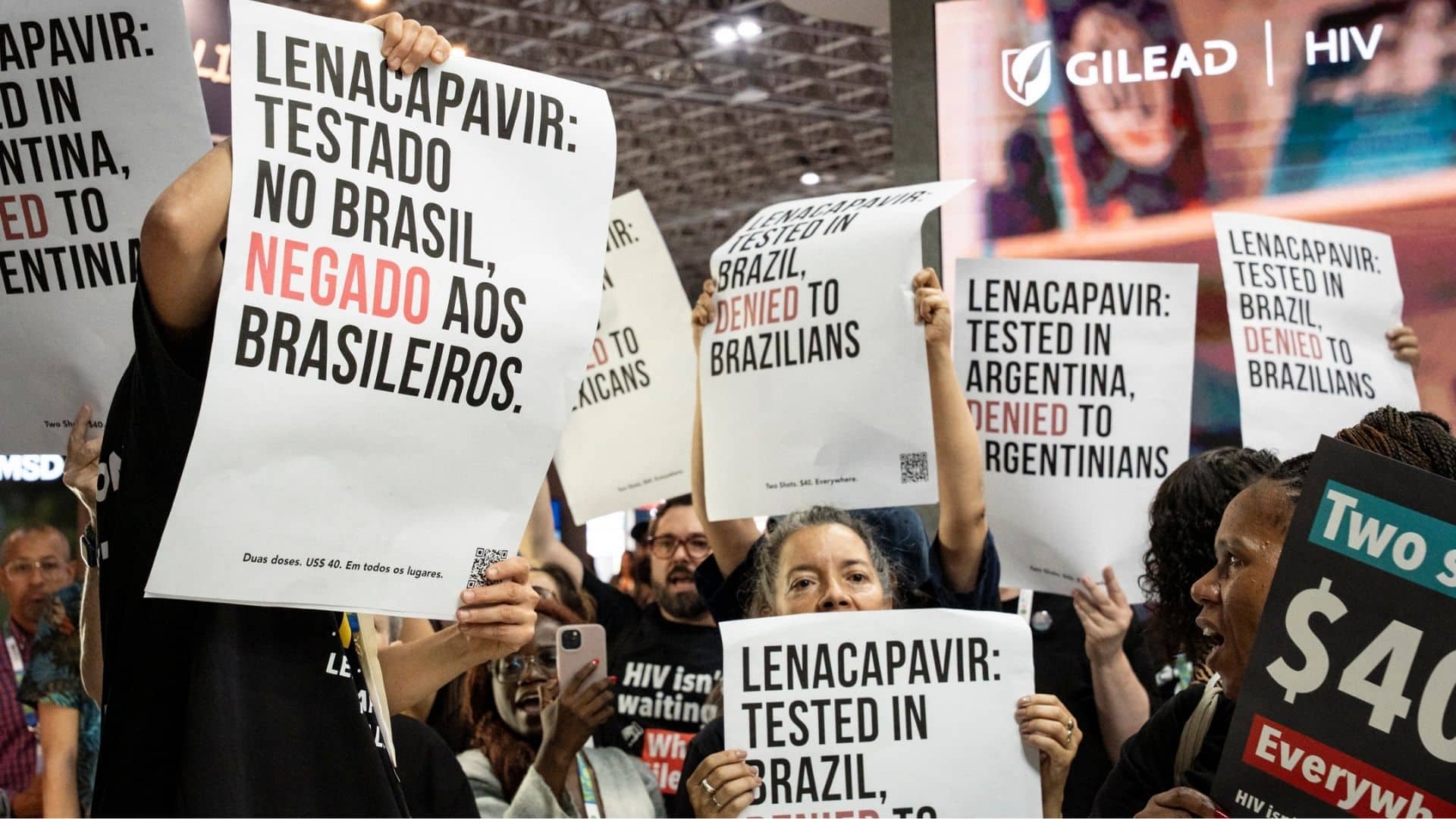 AIDS activists hold signs