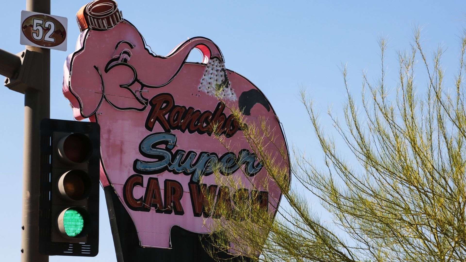 A sign depicts a giant neon elephant 