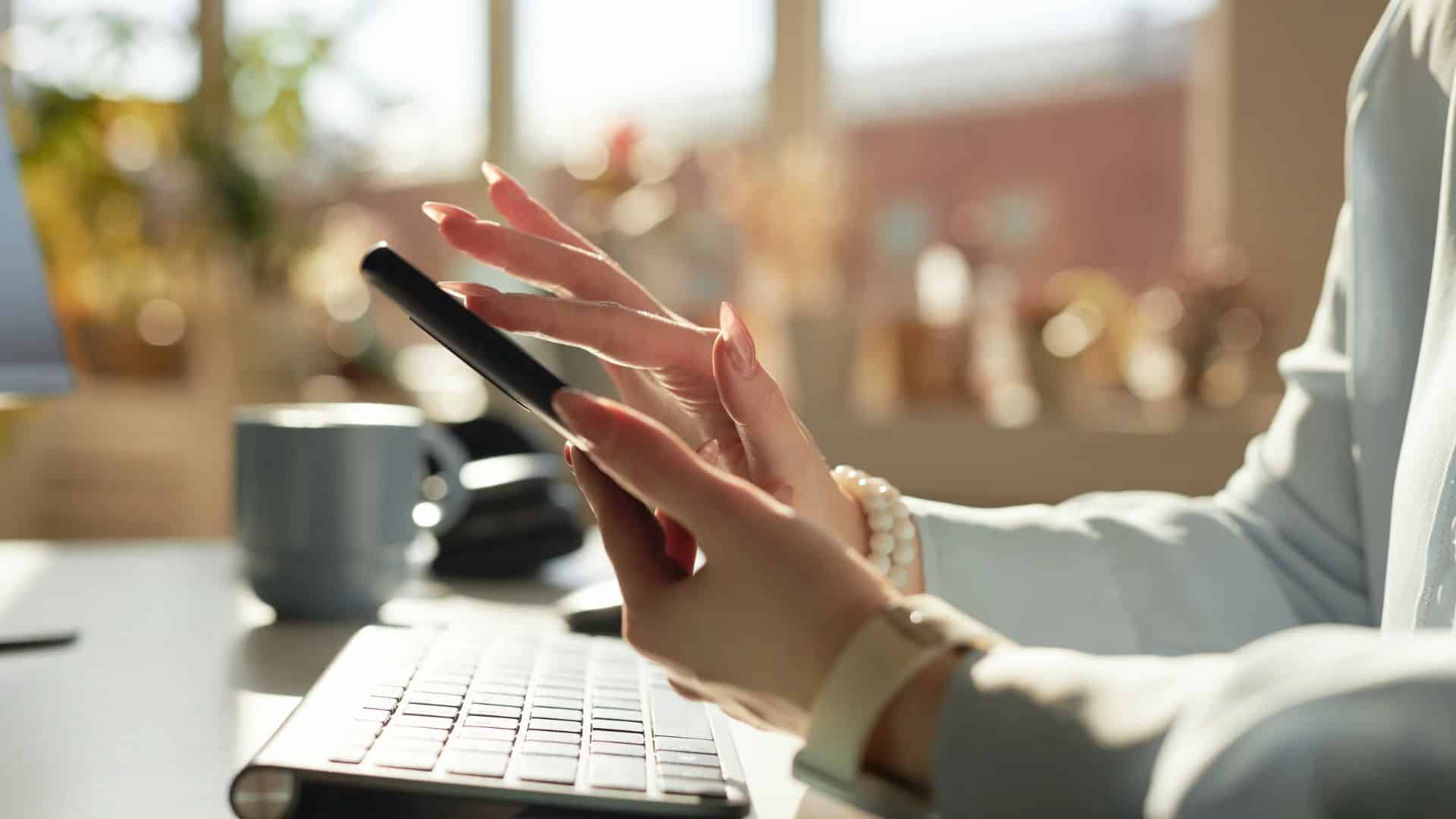 A woman scrolls on her phone. 